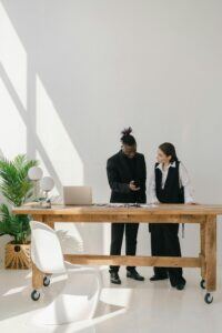 This is an image of a man and woman standing at a desk.