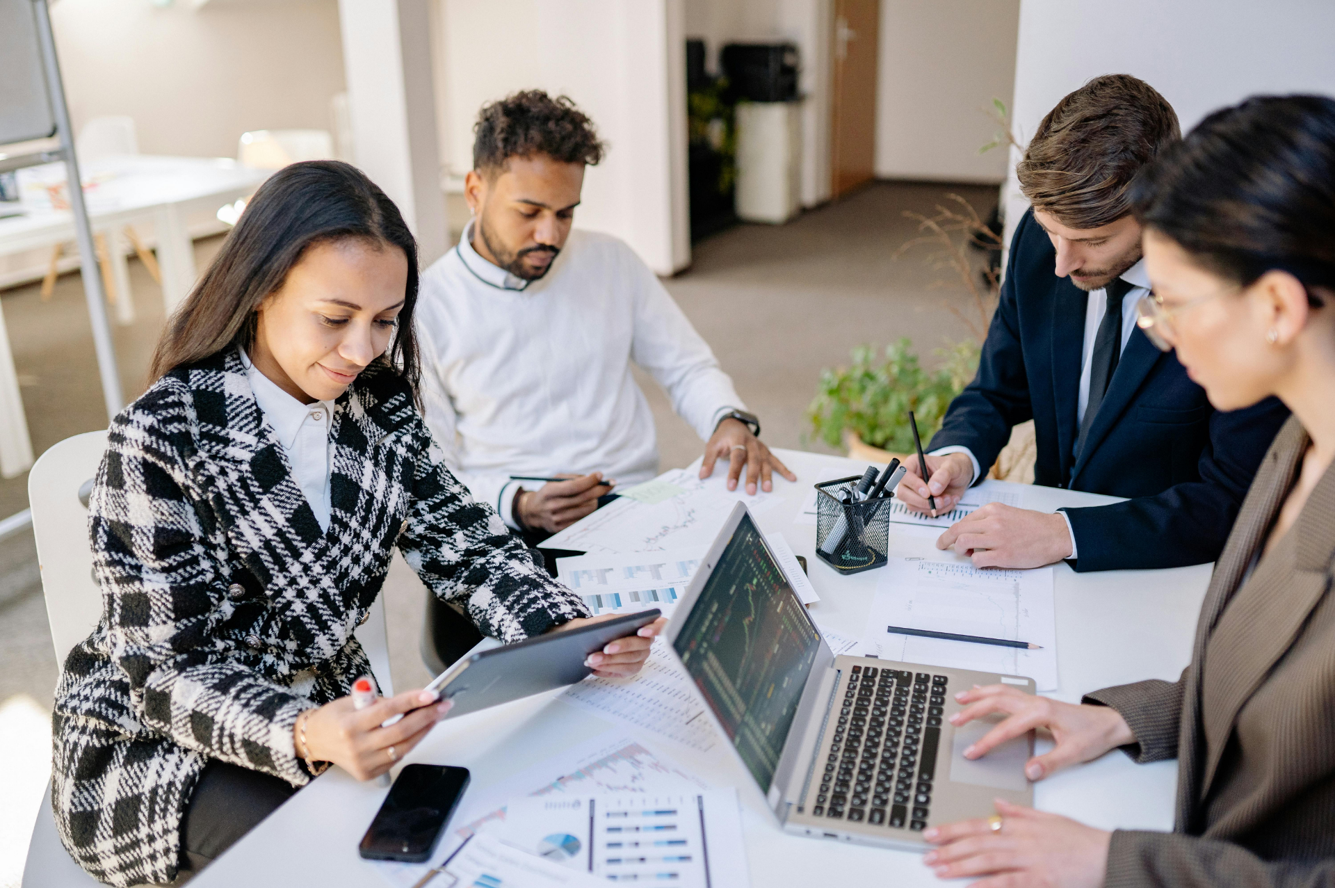 This is an image of four people working in a boardroom