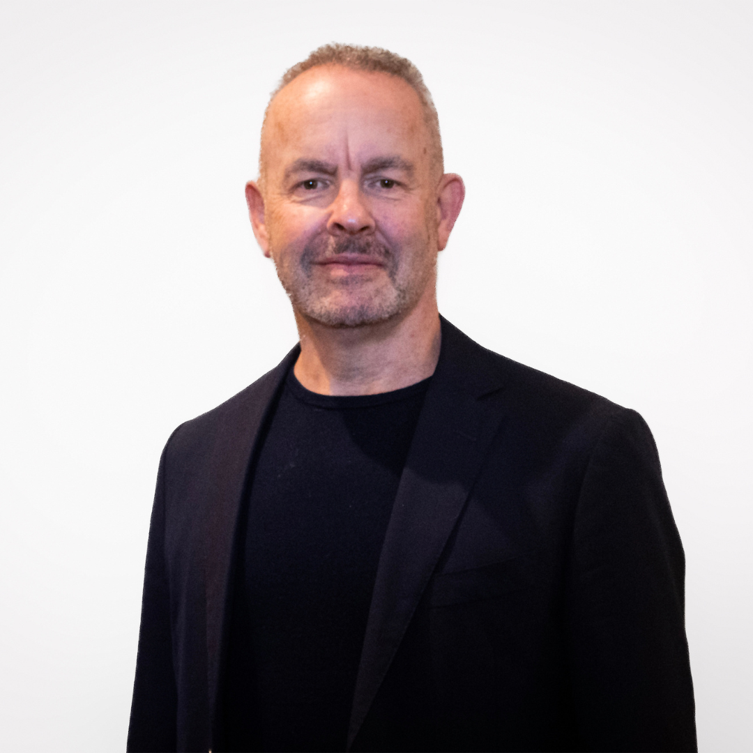 This is an image of a man analysing data on a large screen 