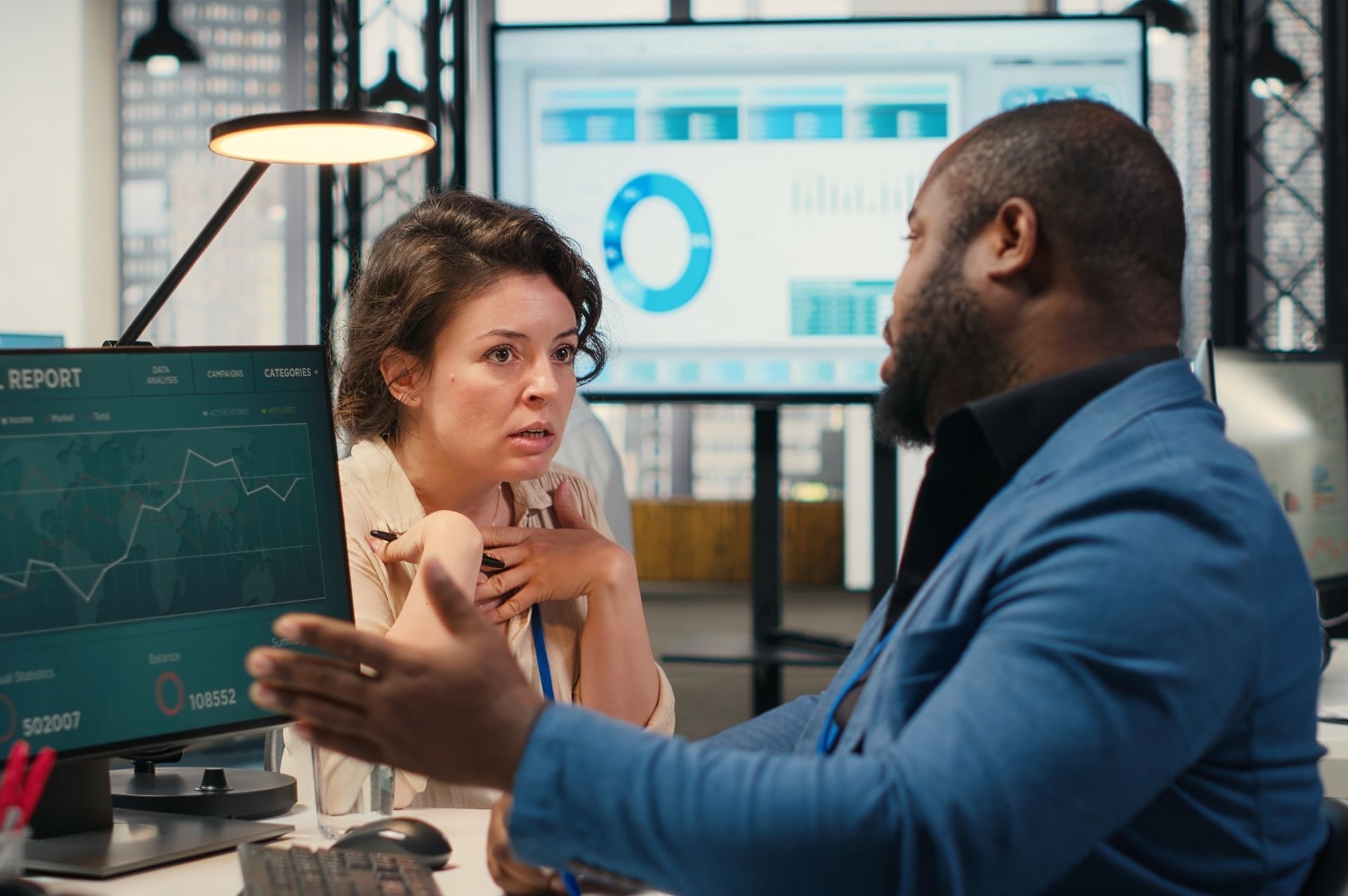 This is an image of a frustrated business woman speaking to a colleague.
