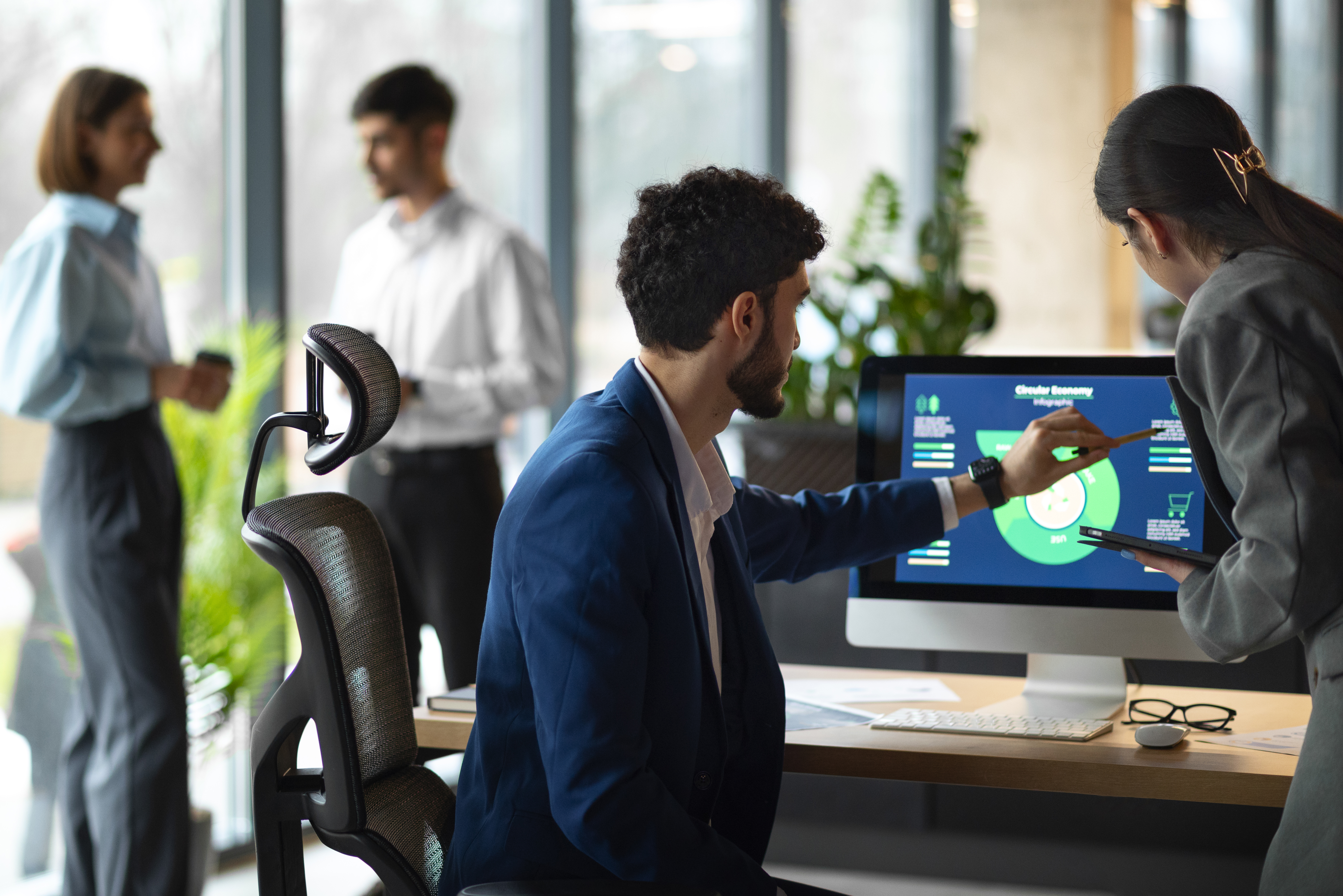 This is an image of people in an office analysing financial data. 