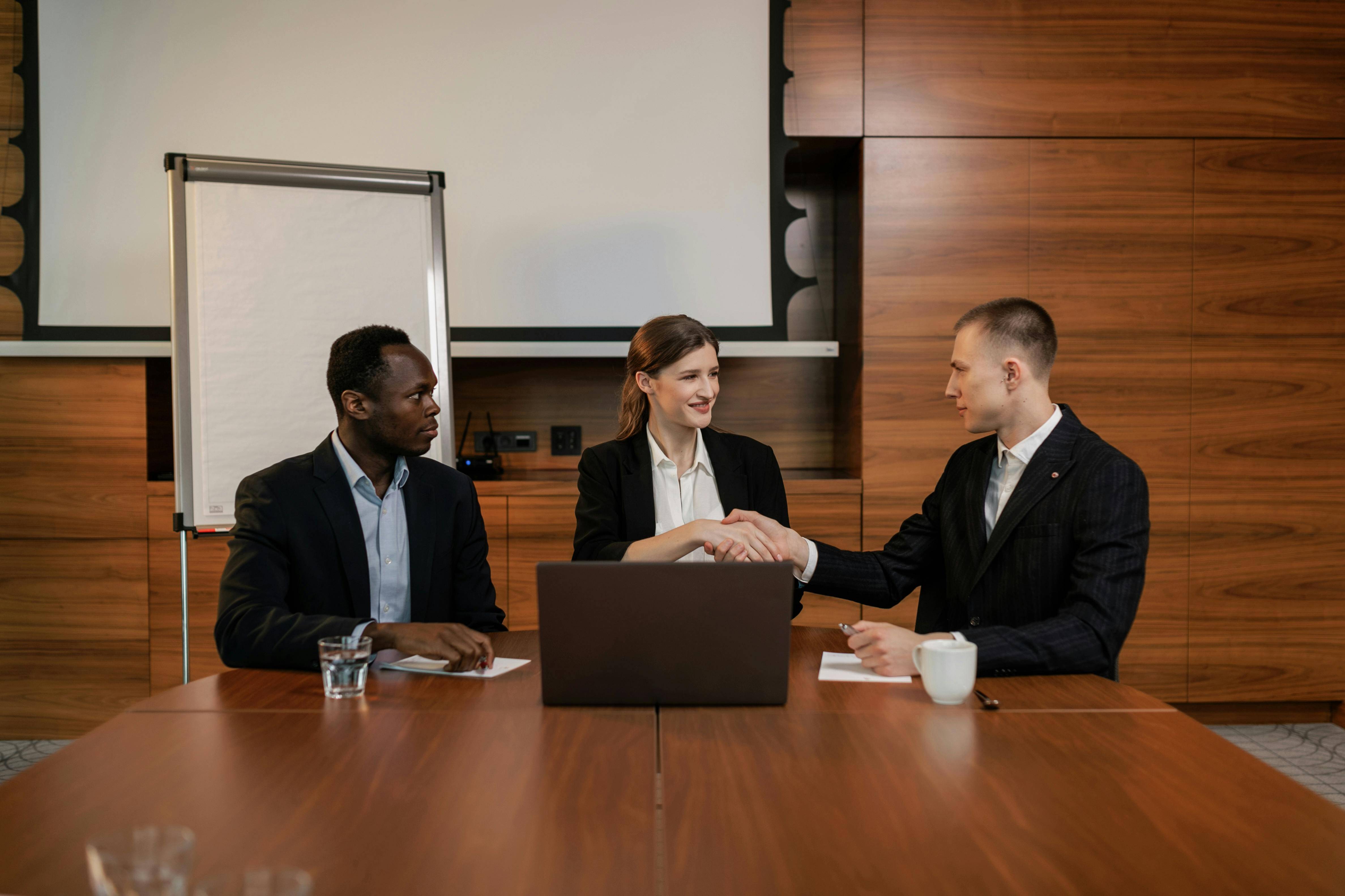 This is an image of people closing a deal in an office.