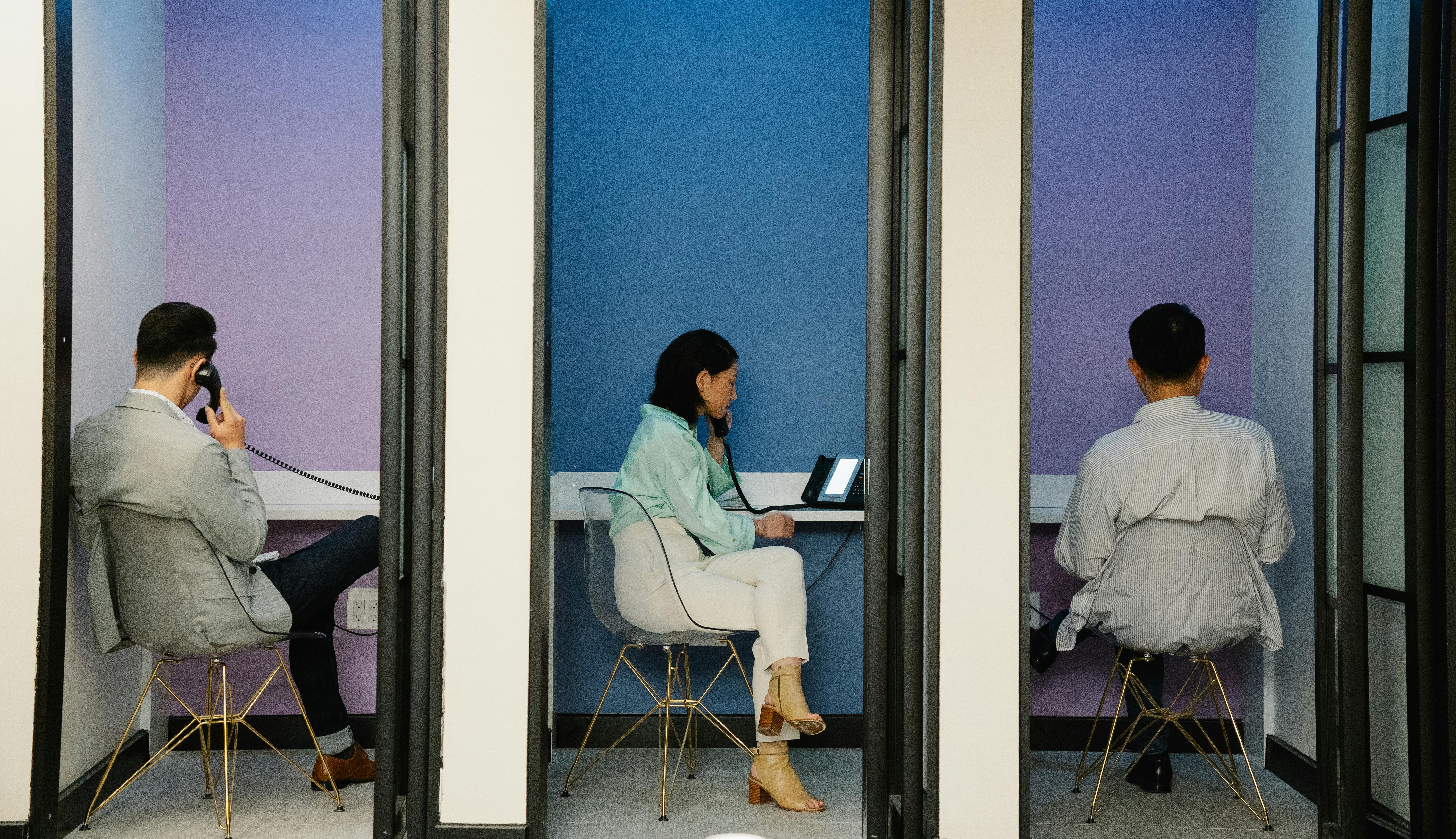 This is an image of people talking on office landlines.