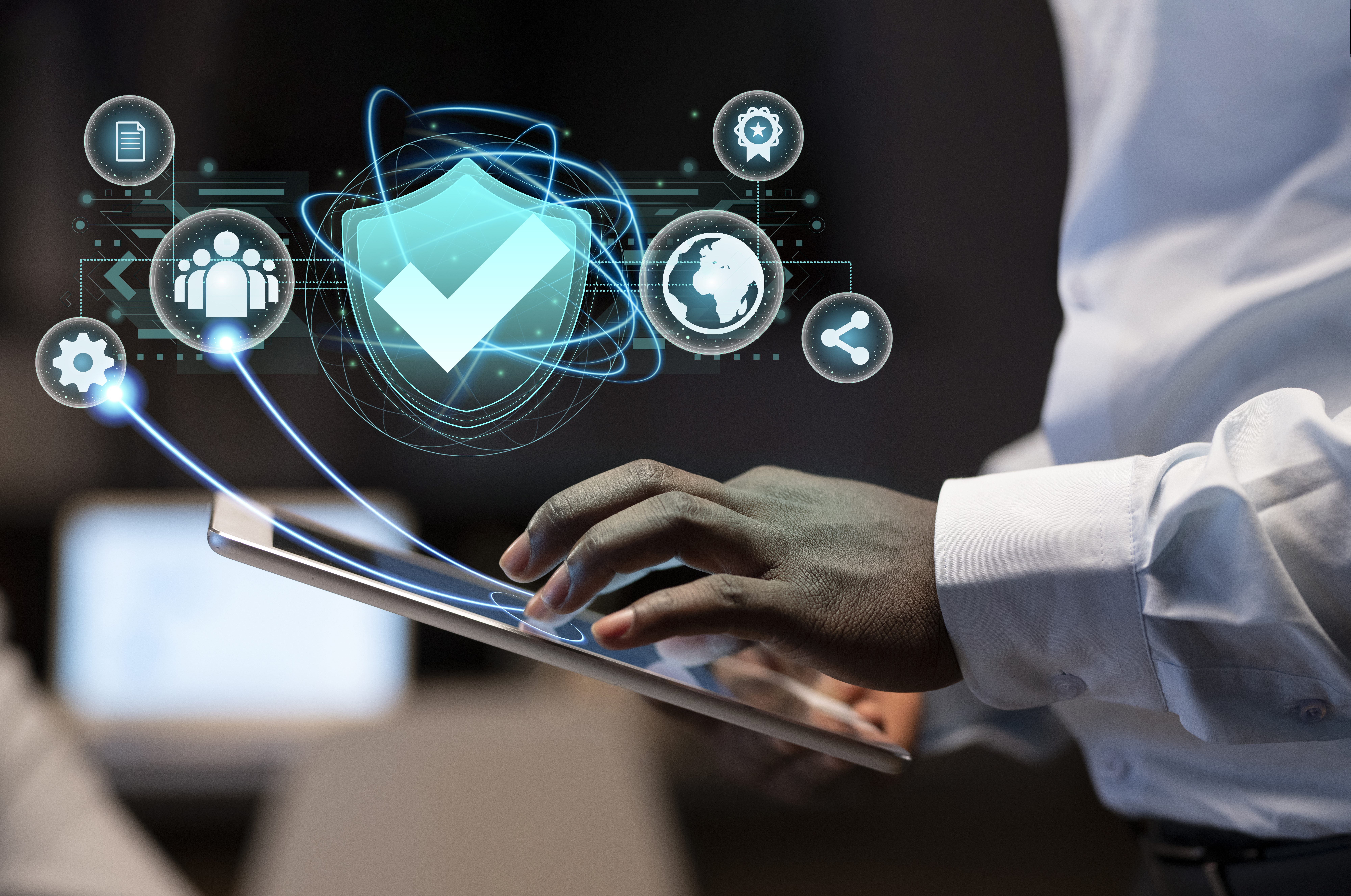 This is an image of a man navigating a cyber security interface on his tablet.